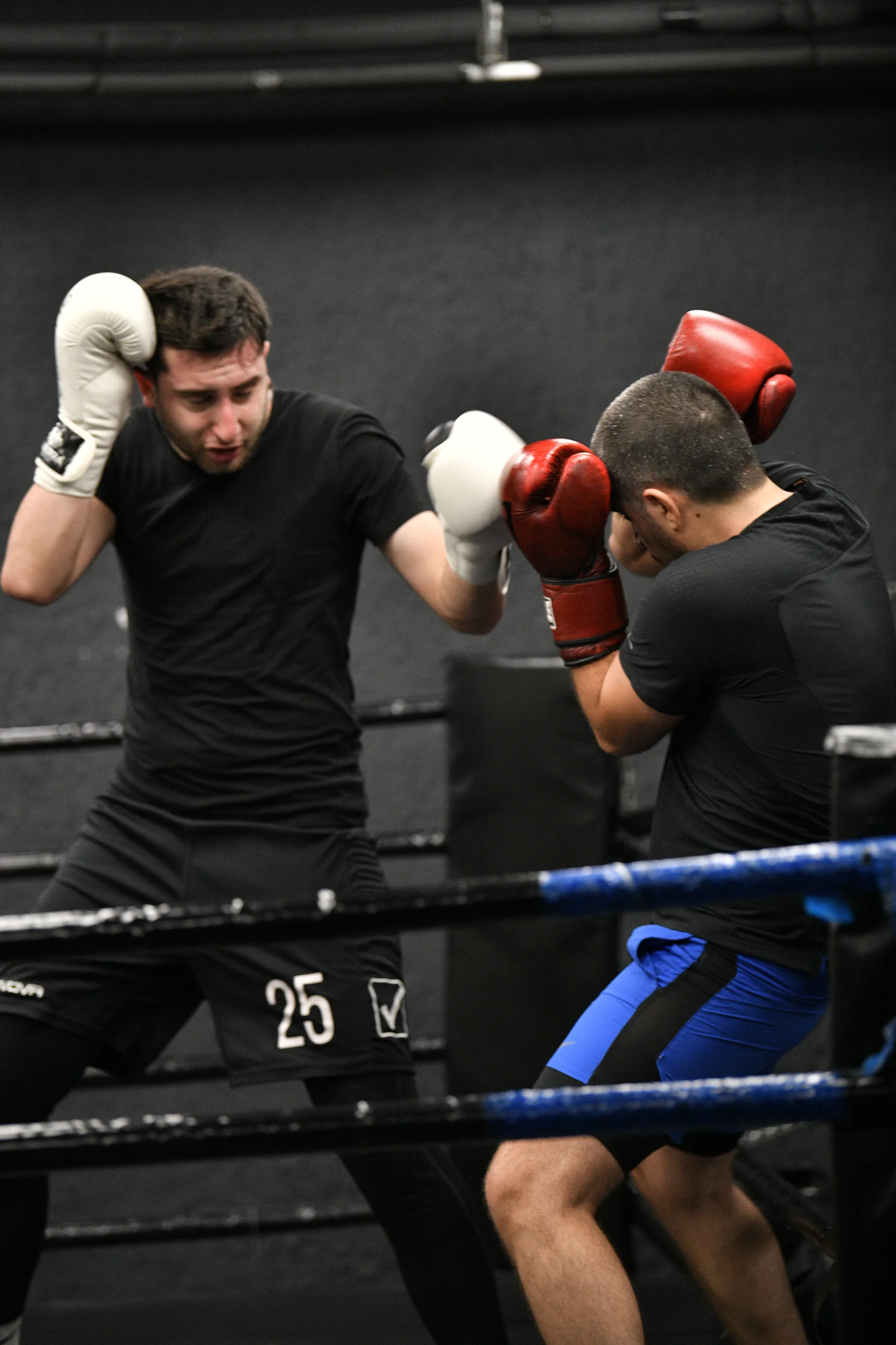 Boxers sparring in the ring at the Gymnasia boxing zone